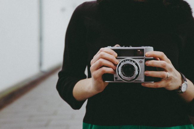 Girl holding a vintage camera