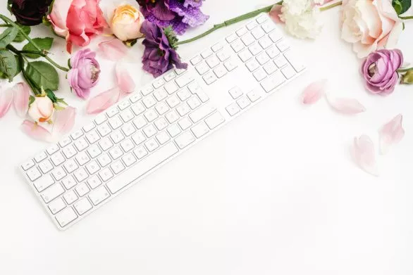 Flat lay with keyboard and flowers
