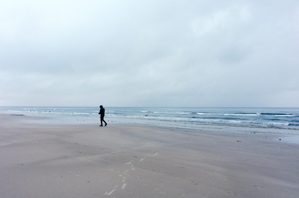 Lonely walker on the beach