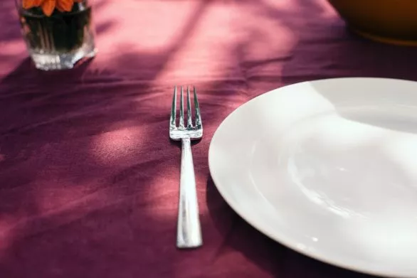 Fork and plate on table