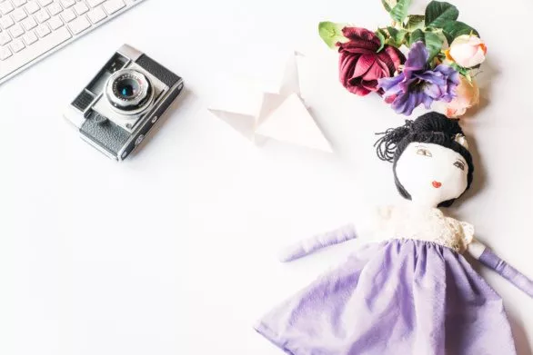 Styled photo with camera and doll