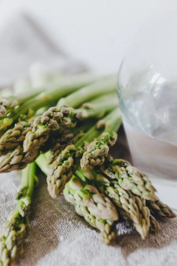 Green asparagus and a carafe with water