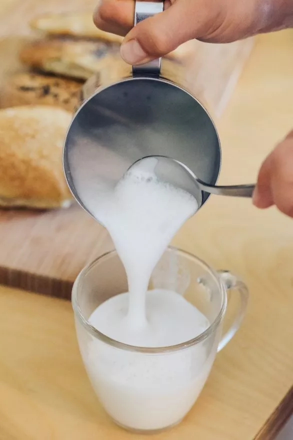 Barista pouring milk