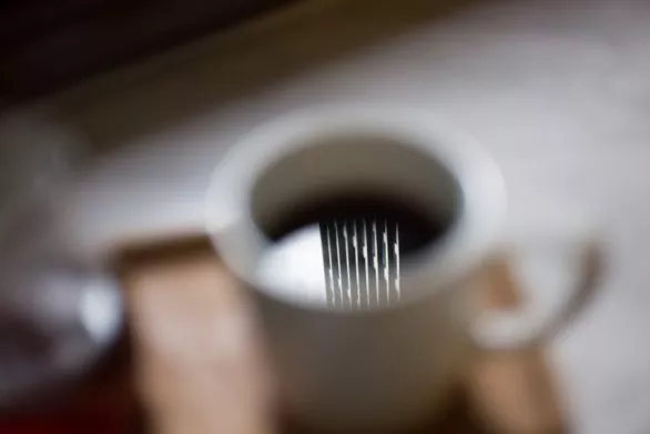 Skyscraper reflection in a coffee cup
