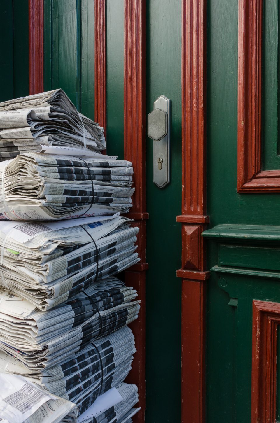 newspapers by door