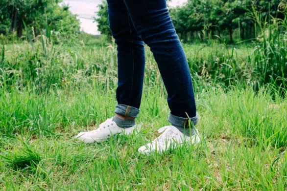 Wearing white sneakers in garden
