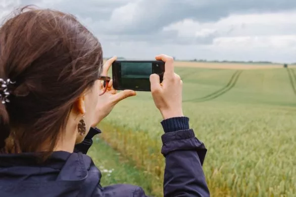 Girl taking landscape on phone