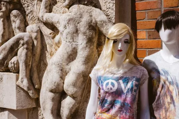 Mannequins next to sculptural relief