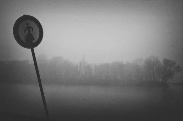 Sign and river in fog