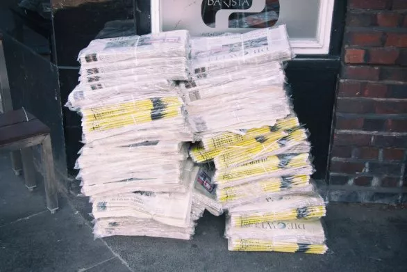 Stack of newspaper on street