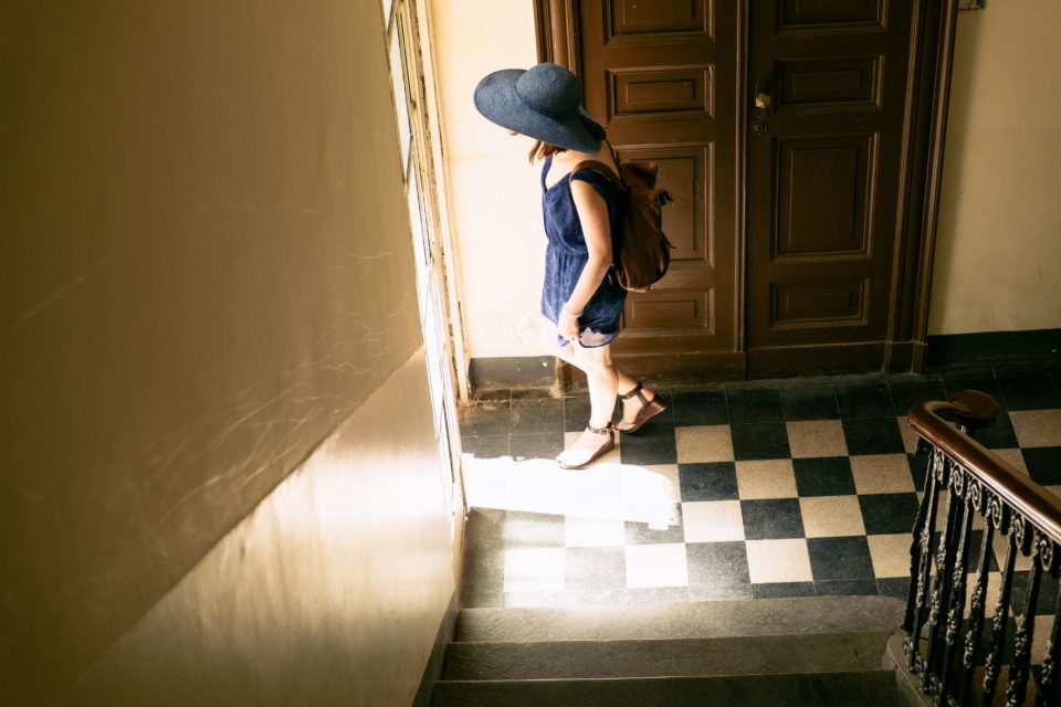 Girl in blue hat on the staircase
