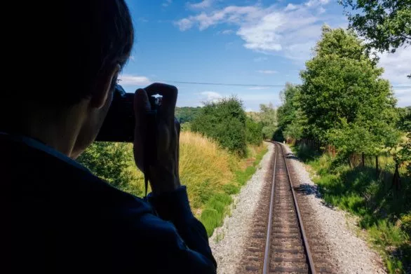 Photographer taking picture of train rails