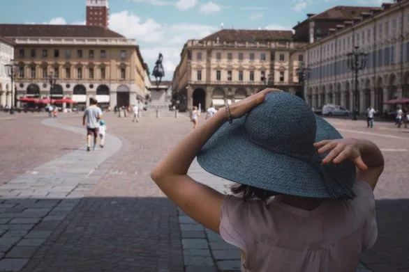 Girl in blue hat on San Carlo square in Turin