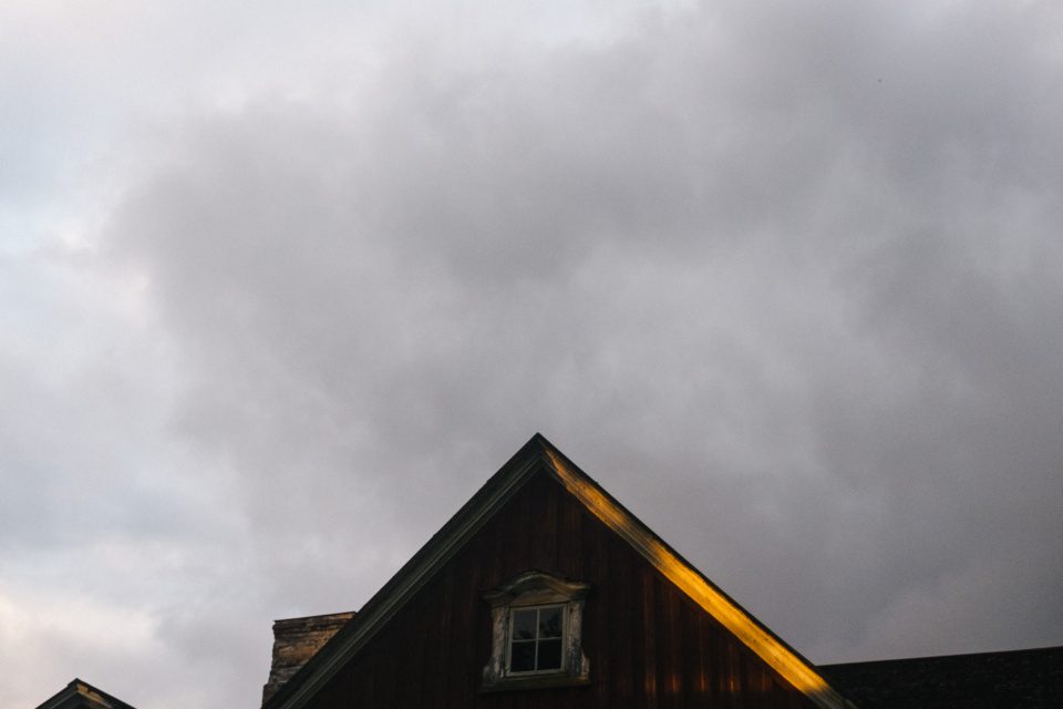 a strip of light on the roof and the evening sky