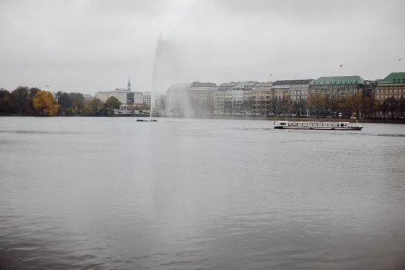 Fountain and boat on Alster, Hamburg