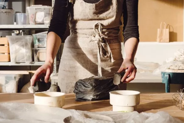 Potter in her studio working with clay