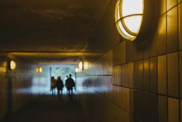 The silhouettes of people walking through the tunnel