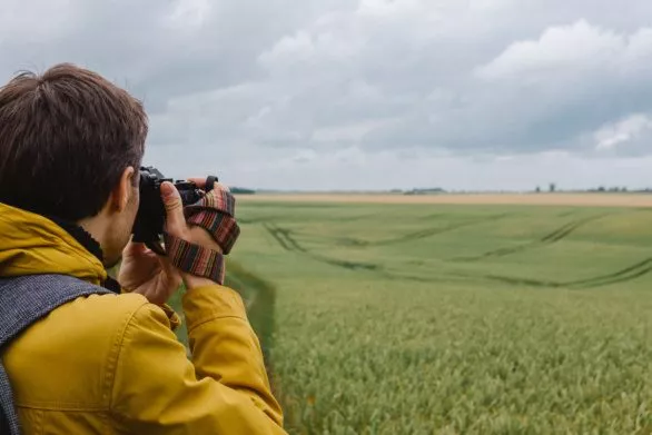 Photographer taking picture of a field