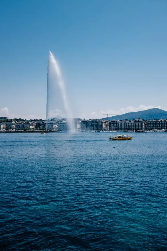 Fountain and boat on Lake Geneva