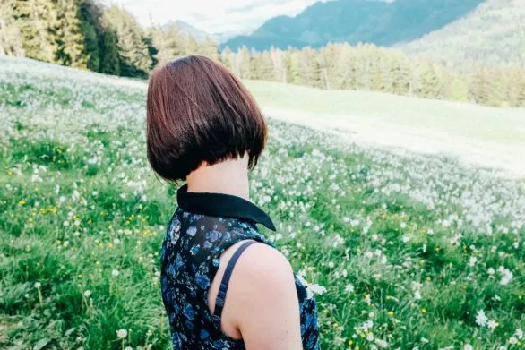 Young woman in a field of flowers in the Alps