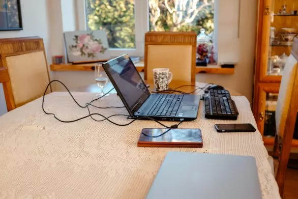 Computer and devices on a table in a living room
