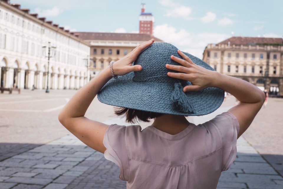 A girl in a blue hat on a square in Turin, Italy