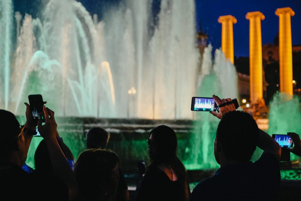 Tourists photograph the magic fountains in Barcelona