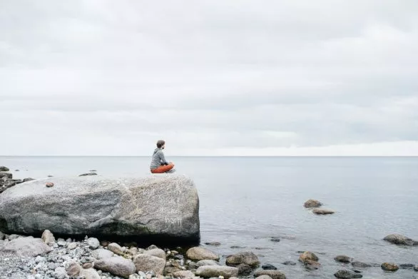 Guy on a rock near the sea