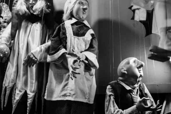 puppets in the storefront window in black and white