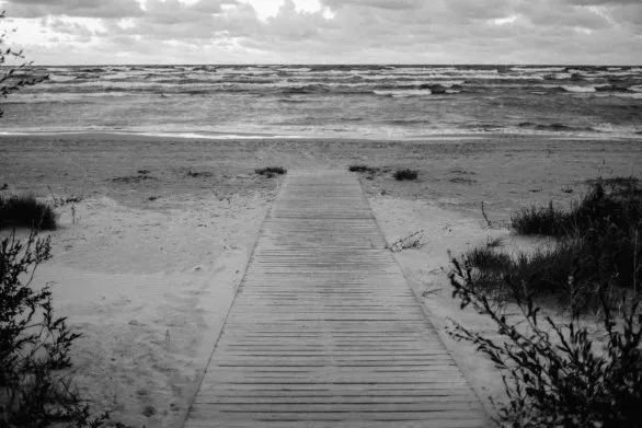 Wooden path to the stormy sea