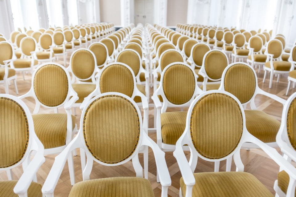 Empty chairs in a baroque concert hall