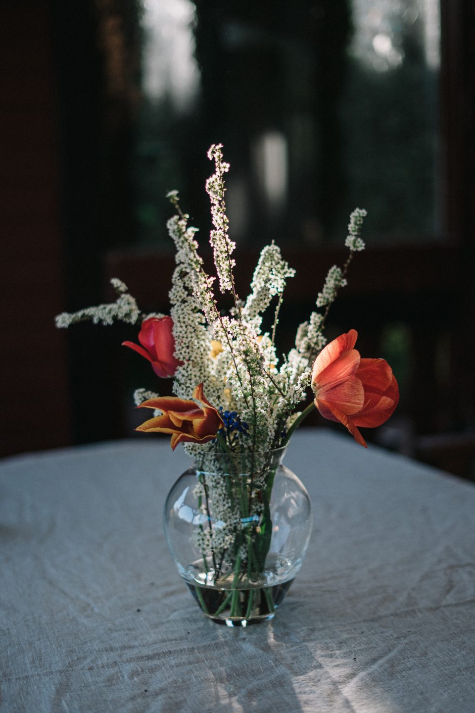 Vase with flowers on table