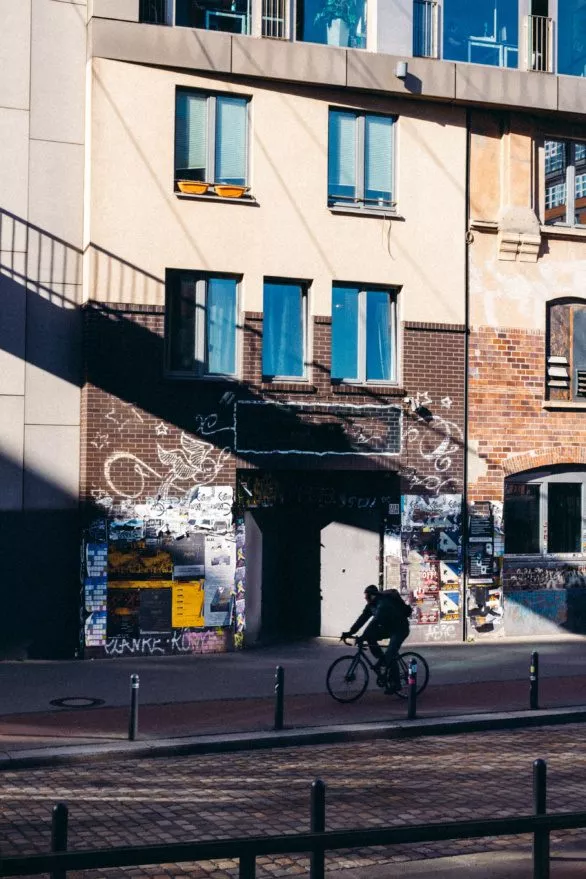 A cyclist rides past a music club in Hamburg, Germany