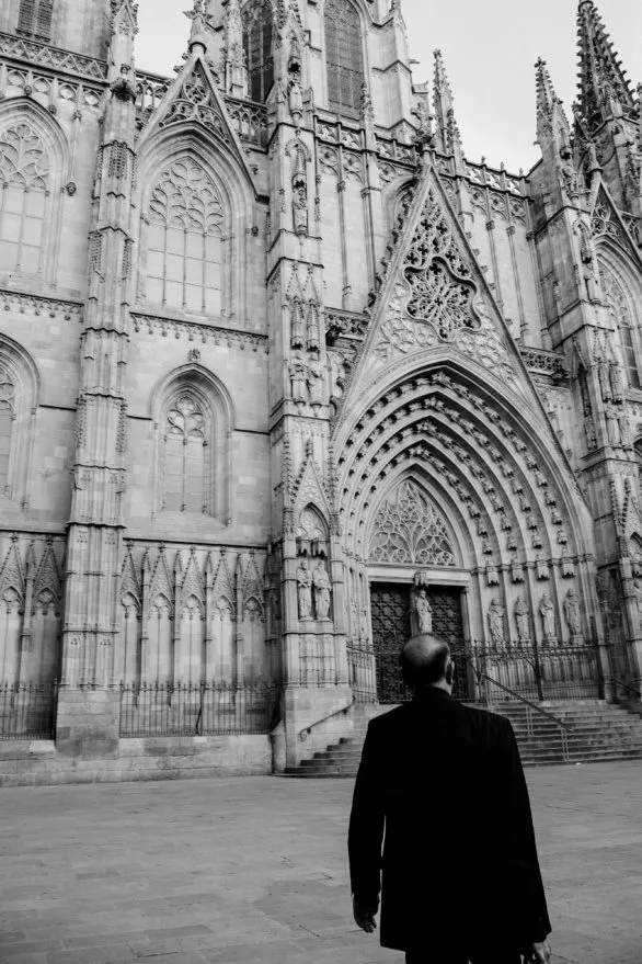 A man next to a closed Barcelona Cathedral in Spain