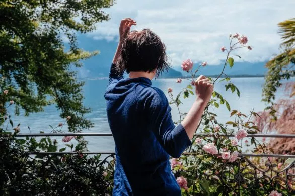 A young woman in a rose garden on Lake Geneva shore