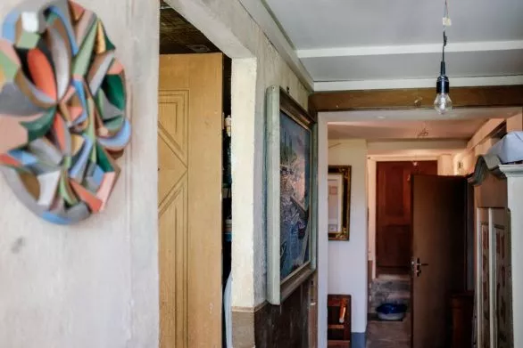 A corridor and walls with paintings in an old house