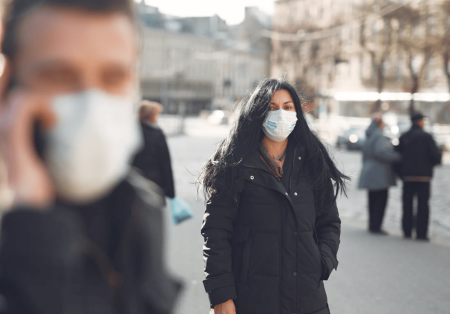 Woman Wearing a Face Mask Outdoors Free Mockup Generator