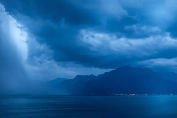 Dramatic sky above Lac Leman Lake Geneva at night