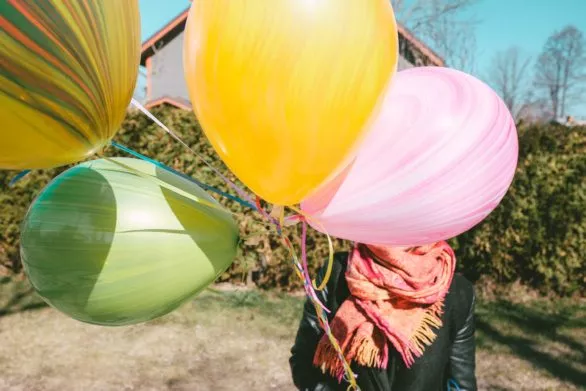 Colored balloons in the hands of a young woman