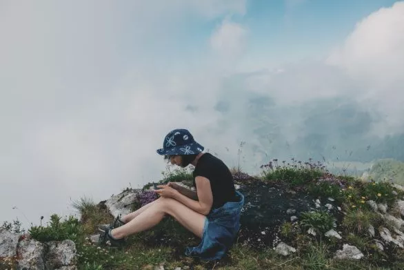 Young female tourist resting on a mountain top