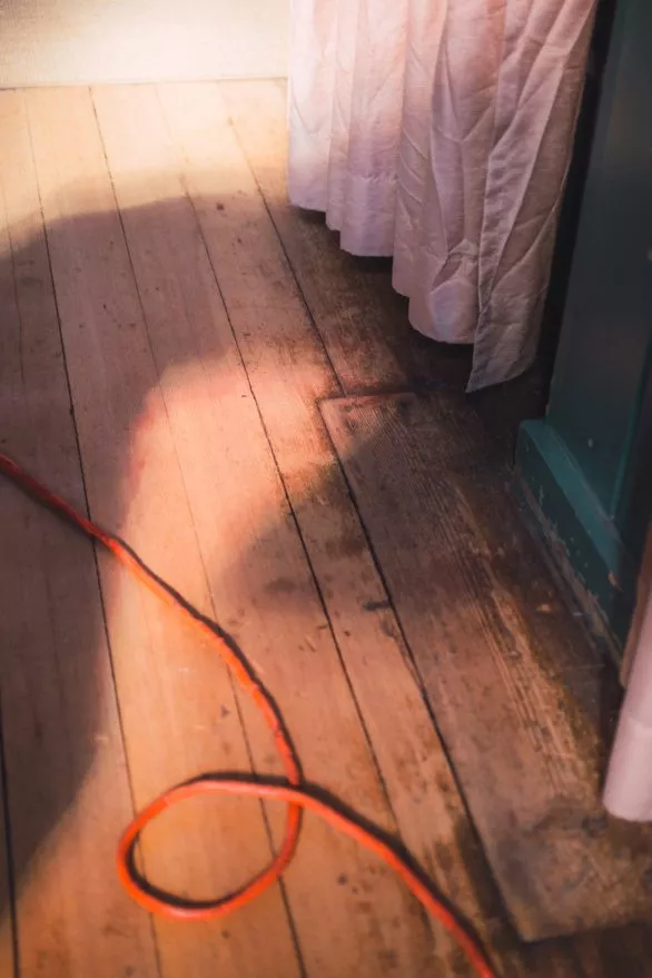 Red wire on wooden floor