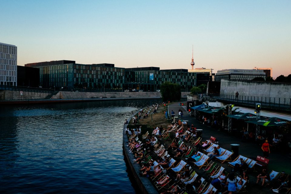 People relaxing in lounge chairs on the banks of Spree in Berlin