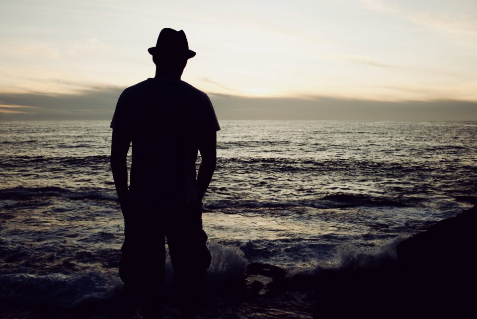 Male silhouette against the sunset on the Atlantic Ocean