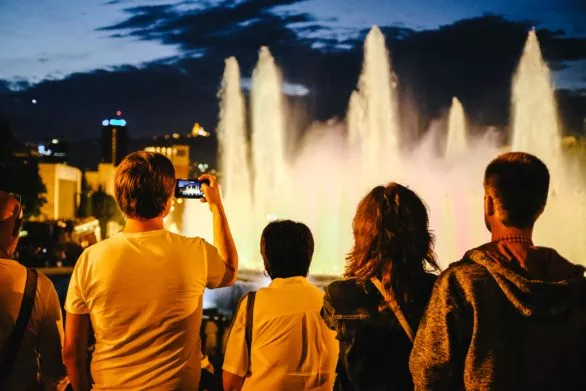 Tourists photograph fountains in Barcelona