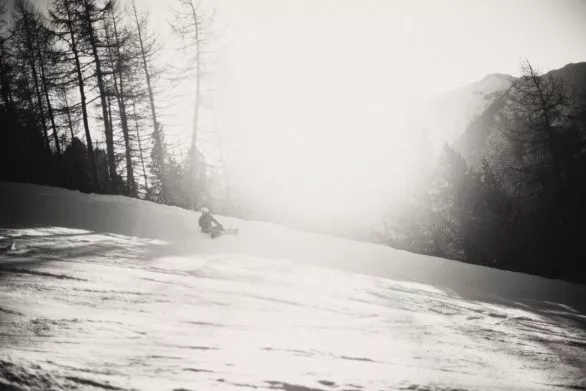 Snowboarder on slope in black and white