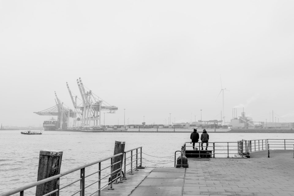 People on banks of the Elbe in Hamburg in black and white