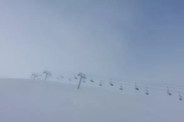 Empty ski lift in fog