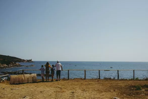 Family looks out over Ligurian Sea panorama in Livorno, Italy