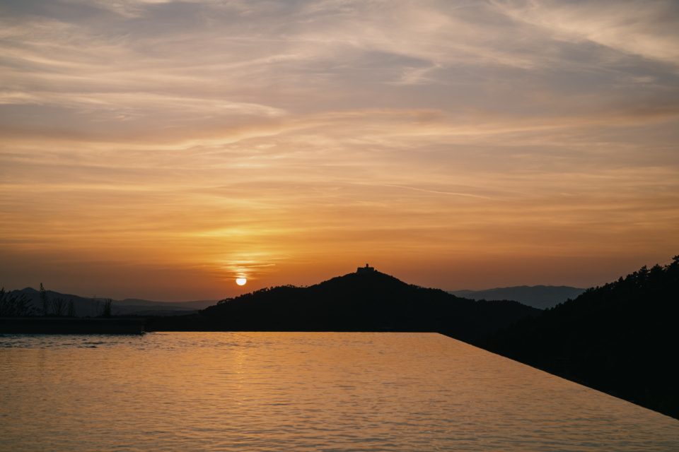 Sunset landscape with infinity pool