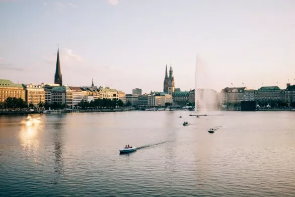 Fountain and boats on Alster in Hamburg